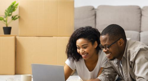 Smiling couple looking at laptop