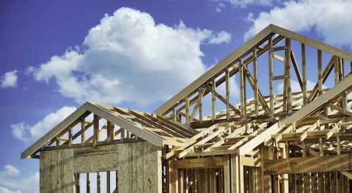 New home lumber frame with blue sky in background 