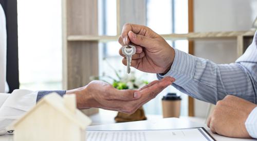 Person handing over home keys