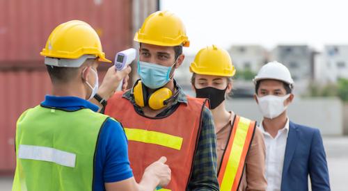 Construction workers in line to receive temperature checks