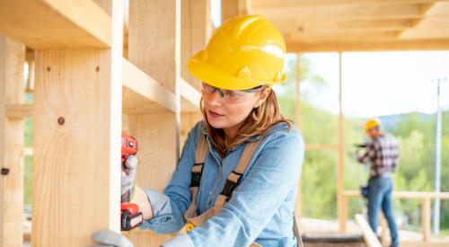 Woman framing a house