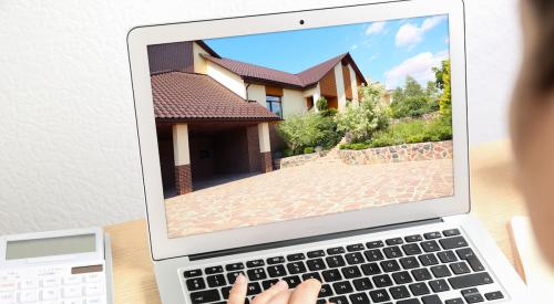 person viewing home on laptop