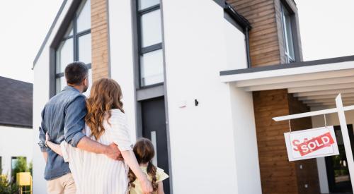 Family walking into new house