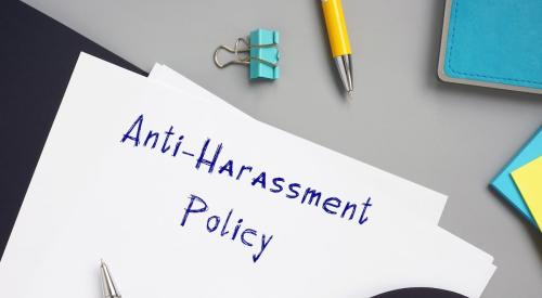 A piece of paper reads, "Anti-Harassment Policy."