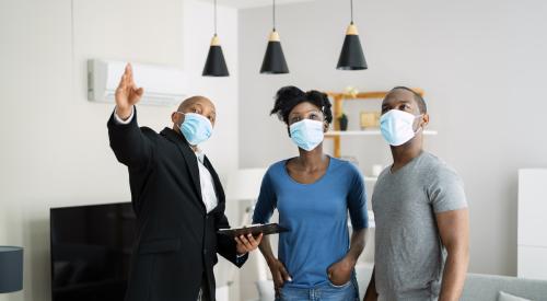 Masked couple at home showing