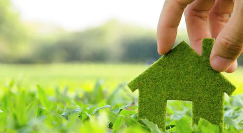 House shape made of grass sitting on field