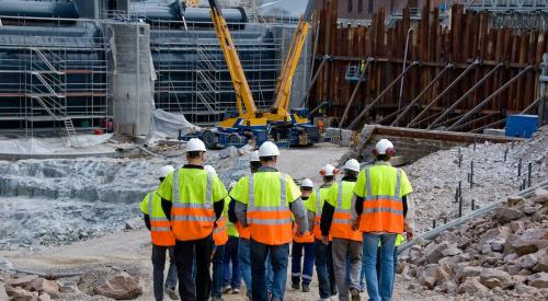 Group of construction workers walking to building site