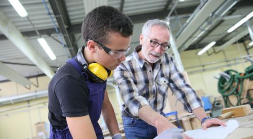 Student being taught construction trades in workshop