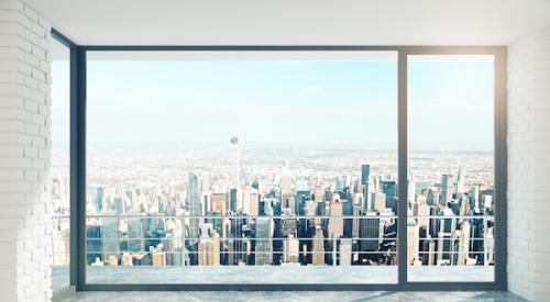 View of a city through the window of a high rise apartment 