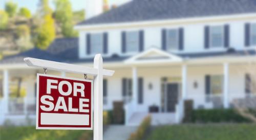 Home with a for sale sign in front yard