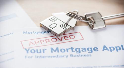 Approved mortgage application with house keys