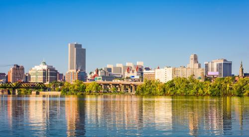 River view of Albany, New York skyline against blue sky