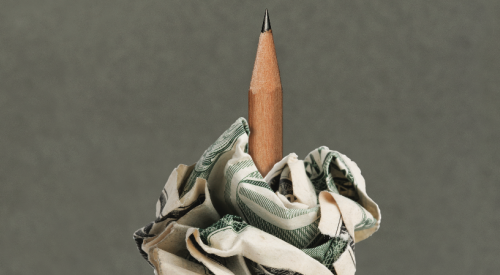 Sharpened pencil skewering crumpled money