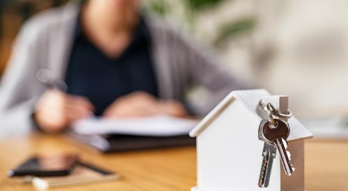 New-home buyer at table with keys