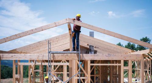 Framers at a job site putting a roof on a custom home.