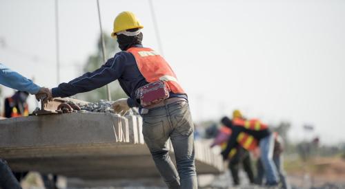 Construction worker moves equipment onsite