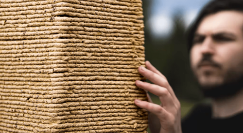 DART researchers next to tower constructed using biodegradable sawdust material