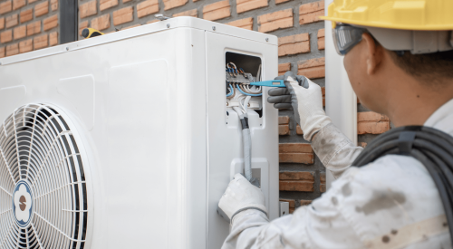 Electrician checking electrical for HVAC unit