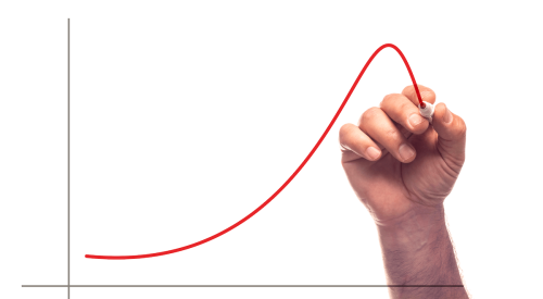 Hand drawing red line on graph going up and then dipping to indicate increased housing starts and then decline in June