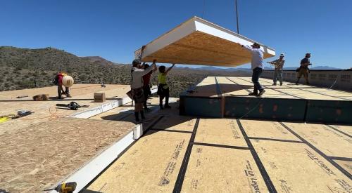 Craning a SIPs roof panel in place