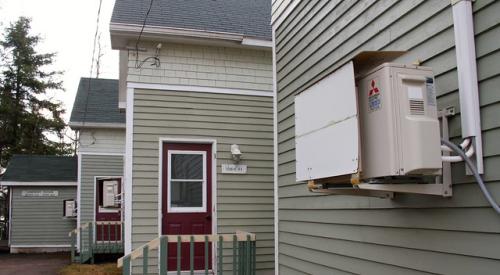 Heat pump installed on house wall