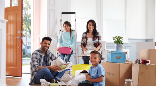 Hispanic family moving into new home and unpacking boxes