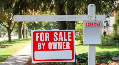 Real estate for sale sign outside of home