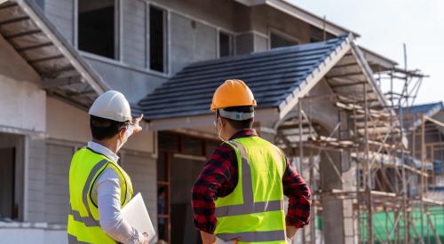 Construction workers looking over project