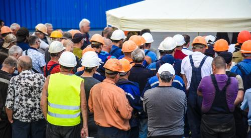 Crowd of construction workers wearing hard hats