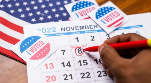 An 'I voted' sticker is on top of a November 2022 calendar.