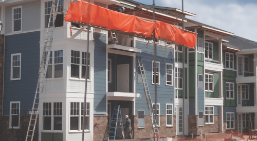 Netting installed with pump jack setup on jobsite for ladder safety