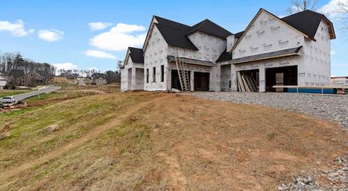 New home under construction with housewrap installed is an example of a clean jobsite