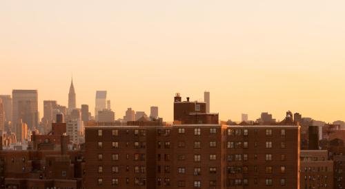 A New York City apartment building with Manhattan in the background