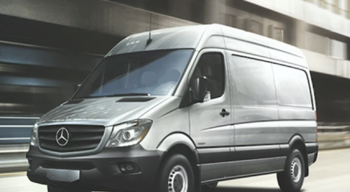 Mercedes 2015 Sprinter cargo van driving down the street