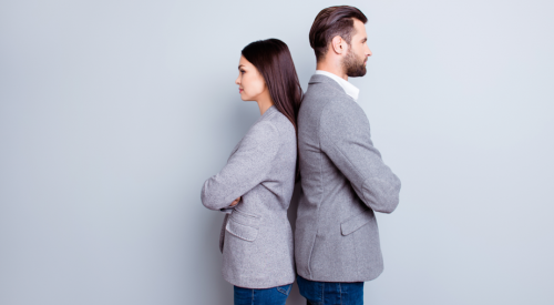 Angry salesperson and marketing person back to back, arms crossed