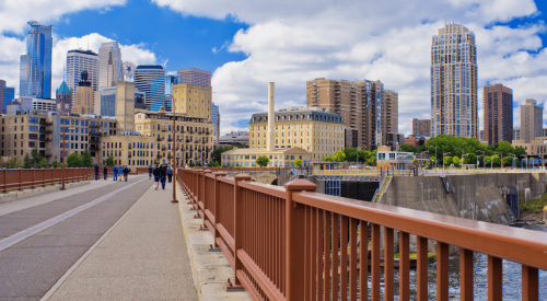 View of Minneapolis skyline with pedestrians on bridge