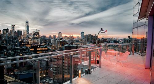 View of New York City at dusk from a penthouse balcony