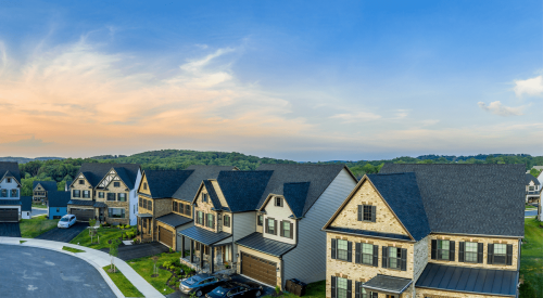 Sunrise over new single-family homes built on cul-de-sac in suburbs