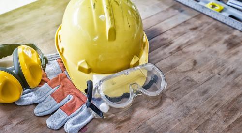 Hard hat, glasses, and gloves for construction worker safety on the job site