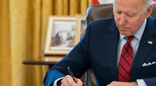 President Biden at desk signing legislation