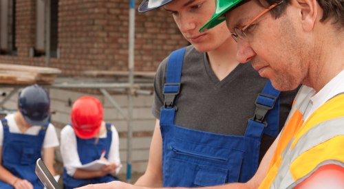 Crew members on construction jobsite meeting