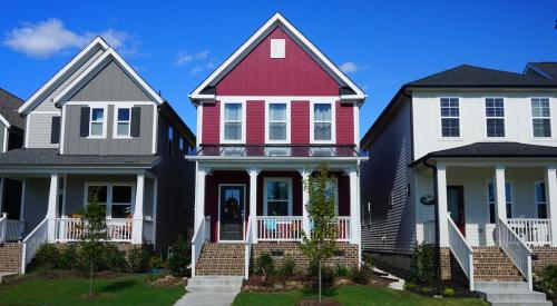 Row of gray, pink, and white houses on street