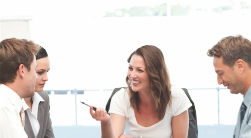 happy employees sitting around a table