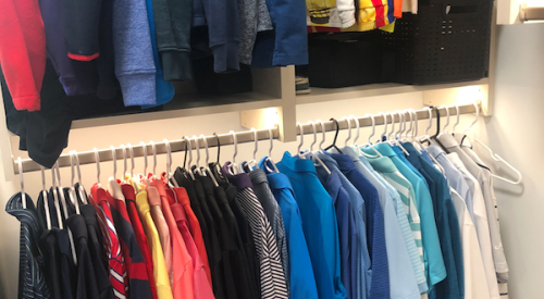 Backlit closet rack with shirts, blouses 