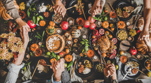 Thanksgiving table set with family and food