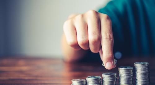 A man points to a stack of coins.