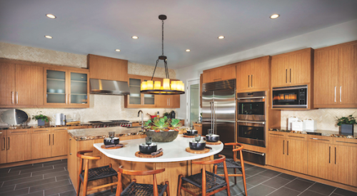 The warm wood cabinets and slate-gray flooring in this kitchen at Truewind, in Huntington Beach, Calif., by TRI Pointe Homes, is a recent example of the transitional look.