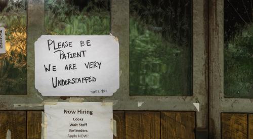 Help wanted sign posted in window of restaurant