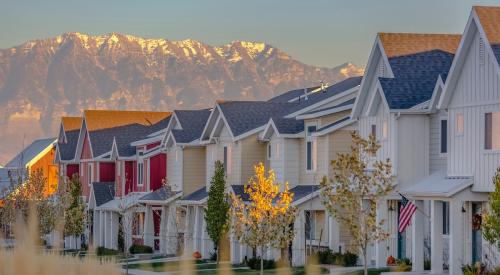 Colorful Utah homes in a row backdropped by mountain range