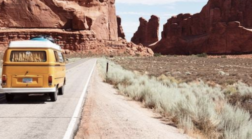 Volkswagen van on desert canyon road. 